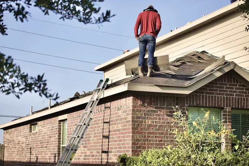 Professional roofer working on a residential roof in Downtown Greenwich